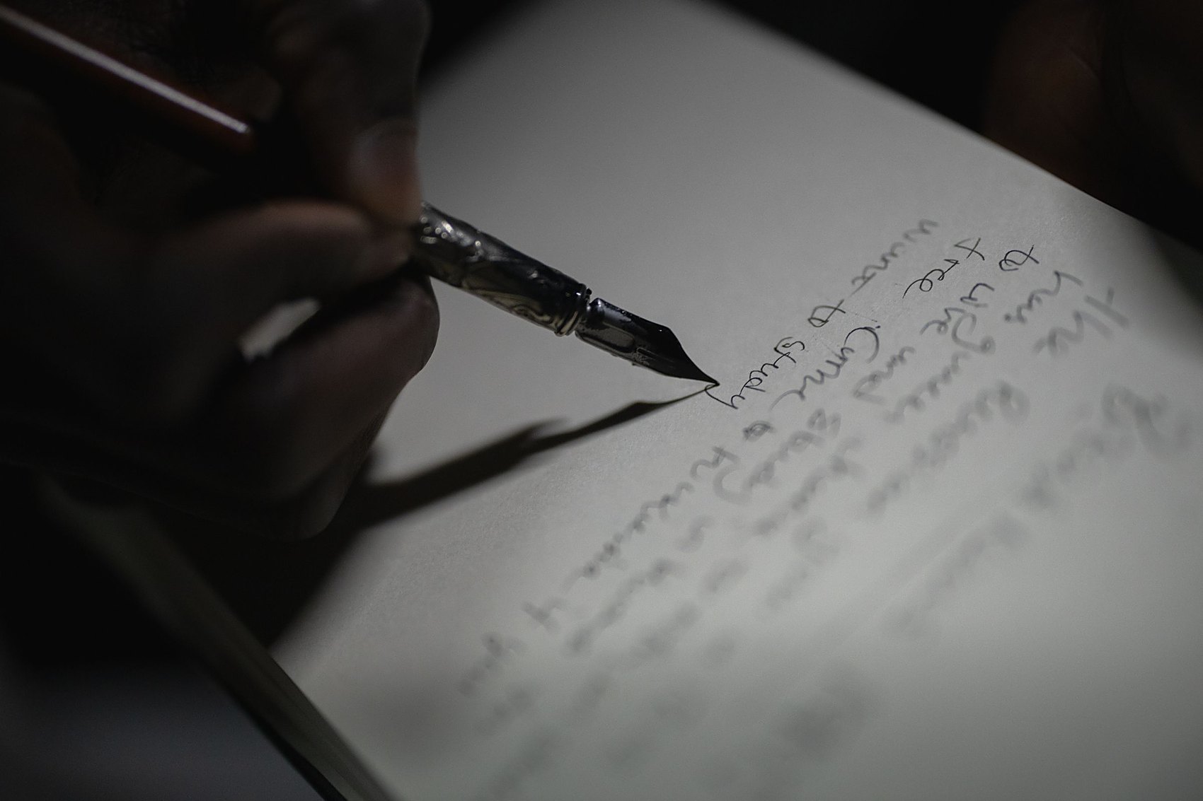 A fountain pen signing a handwritten document